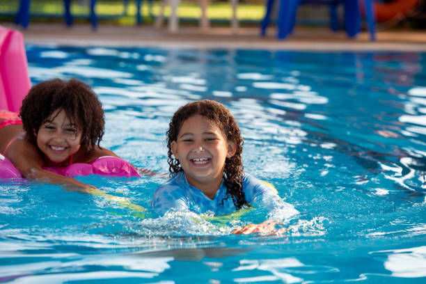 istock Multiracial elementary-age girls having fun in the swimming pool. 1423972952