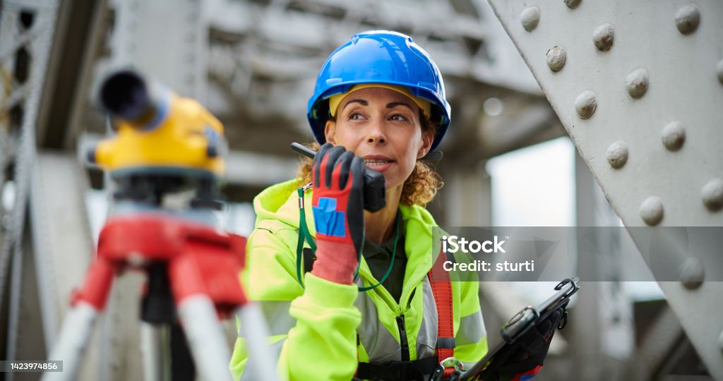 female steel surveyor female surveyor Construction Site Stock Photo