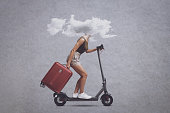 Woman with head in a cloud riding a scooter