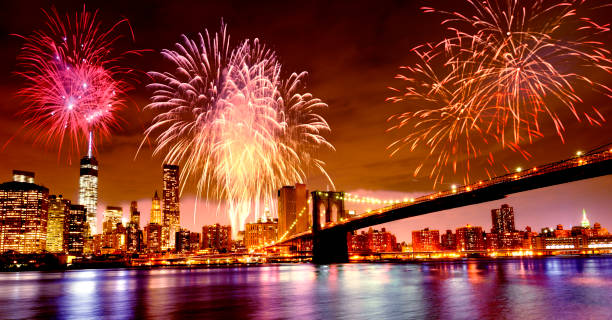 Fireworks over Brooklyn Bridge and One World Trade Center. stock photo
