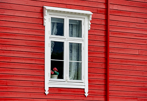 Hellesylt in Norway a typical wooden house with white window surround.