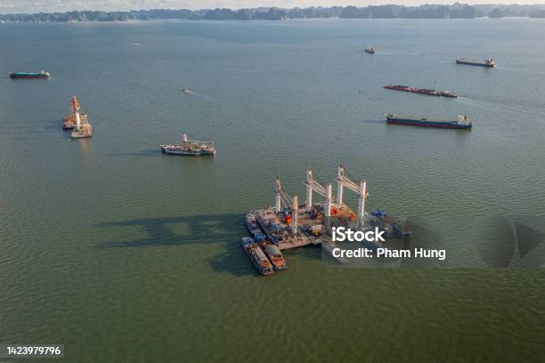 Lighter With Heavy Crane And Logistic Cargo Ships On Ha Long Bay Stock Photo - Download Image Now