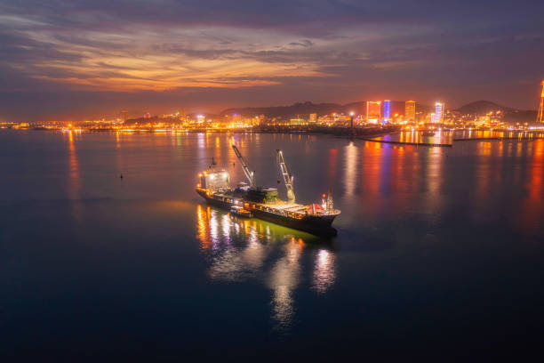 Drone view of heavy logistic cargo ship on Ha Long bay, in sunset Ha Long city, Quang Ninh province, north Vietnam