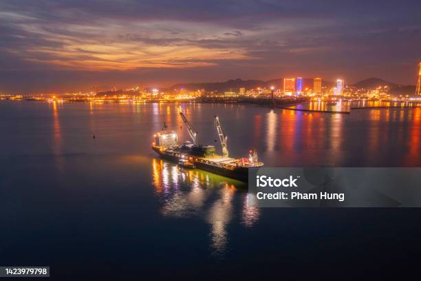 Heavy Logistic Cargo Ship On Ha Long Bay In Sunset Stock Photo - Download Image Now - Vietnam, Trading, Box - Container
