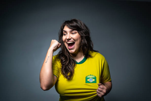 istock Brazilian young fan celebrating on yellow uniform 1423980578