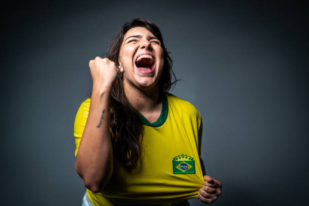 istock Brazilian young fan celebrating on yellow uniform 1423980601