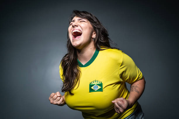 Brazilian young fan celebrating on yellow uniform