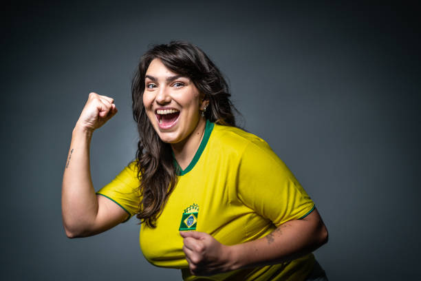 istock Brazilian young fan celebrating on yellow uniform 1423980625