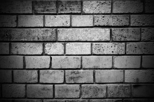 istock Black and white stone brick wall obsolete vignette background 1423980754