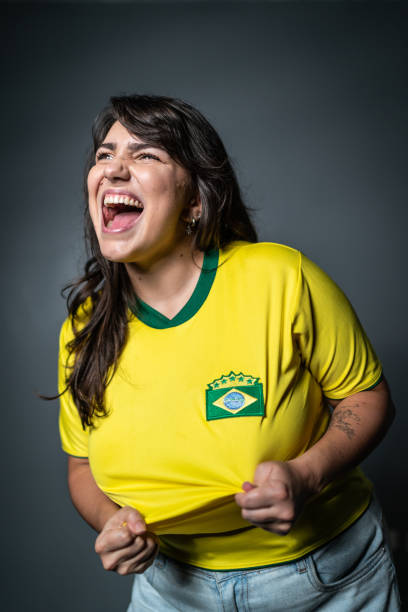 istock Brazilian young fan celebrating on yellow uniform 1423981478