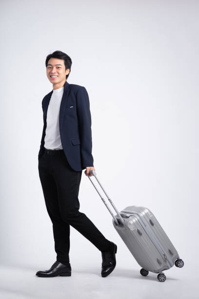 istock Young business man wearing a suit posing on a white background 1423983020