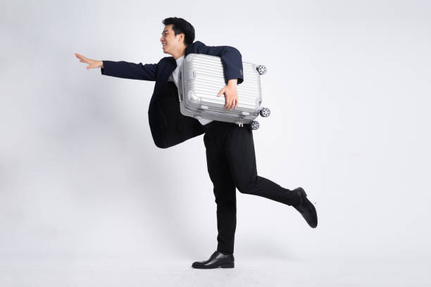 istock Young business man wearing a suit posing on a white background 1423983025