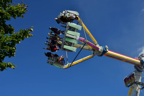 Leuven, Flemish-Brabant, Belgium - September 11, 2022: people having fun in the big pendulum swinging up and down on a Sunday afternoon