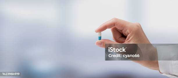 Professional Doctor Holding A Pill Stock Photo - Download Image Now - Antibiotic, Giving, Capsule - Medicine