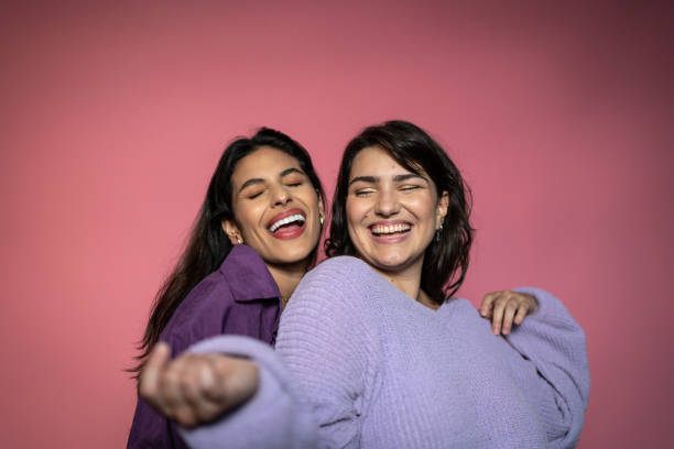 Young women on a pink background