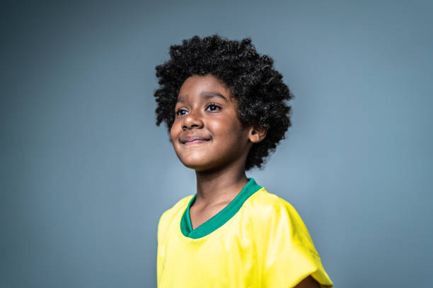 Pride boy looking away wearing brazilian team colors on a gray background Pride boy looking away wearing brazilian team colors on a gray background only boys stock pictures, royalty-free photos & images