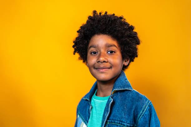 istock Portrait of a boy on a yellow background 1423986208