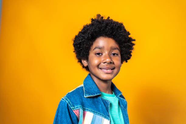 istock Portrait of a boy on a yellow background 1423986238