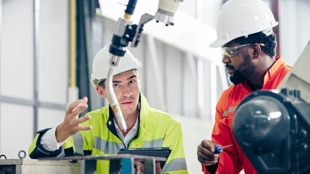 istock Multiracial Engineer colleague discussing in Robot Development Plant 1423989794
