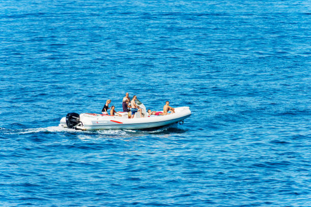 Parasailing on Aegean sea, town of Kuşadası in Turkey on a sunny summer day, View Of Kusadasi Skyline At Aegean Coast, Turkey.