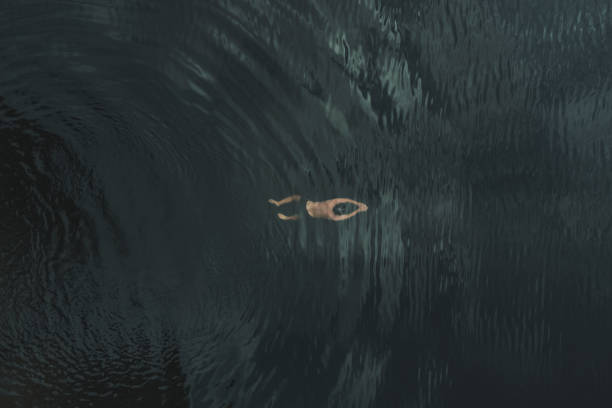istock A man swims under water. Deep transparent water. Drone view. 1423991596