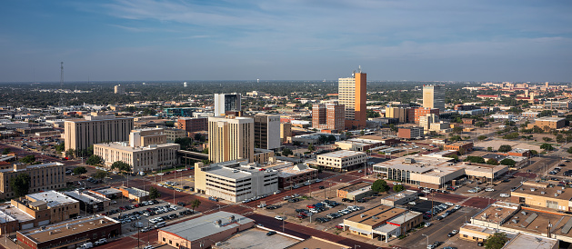 Downtown Lubbock, Texas, is shown from an aerial view on a summer morning.  Texas Tech University is in the distant background.