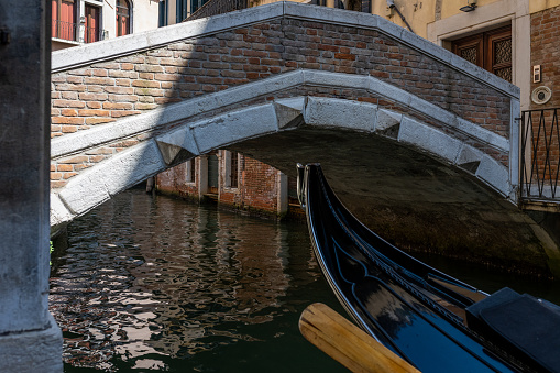 A teenager curiously explores hundreds of alleys and canals, bridges, and buildings in Venice. Teenage curiosity, summer, backpacking, vacation trip.