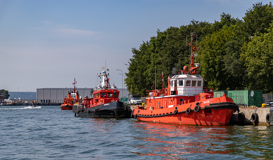 Gdansk, Poland - August 14, 2022: A picture of three tug vessels in the Port of Gdansk.