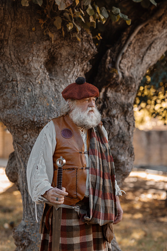 A reenactor represents 80 percent of defenders of the Alamo who were Scottish. Texas Independence Day re-enactment at Acton, Texas, cemetery where Elizabeth Crockett, Davy's wife, is buried. Full-length.