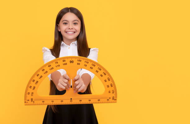 istock cheerful kid in school uniform hold mathematics protractor for measuring, high school 1424001813