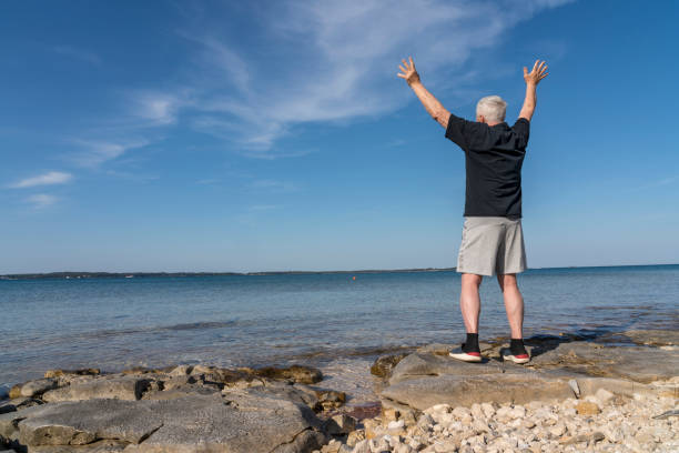 Men exercising on stony beach early in the morning
