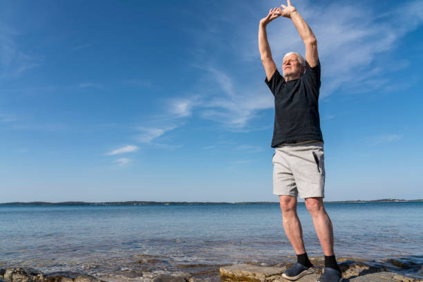istock Men exercising on stony beach early in the morning 1424002386