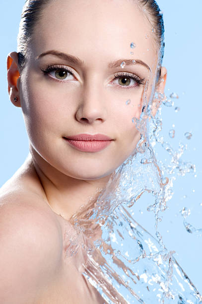istock Young Female face with splash of water 142400265