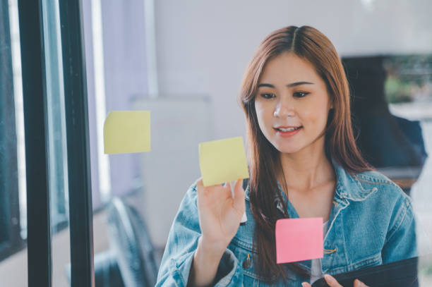 istock Web designers creating planning and analyzing with Colorful sticky notes on the office board.web design concept 1424003413