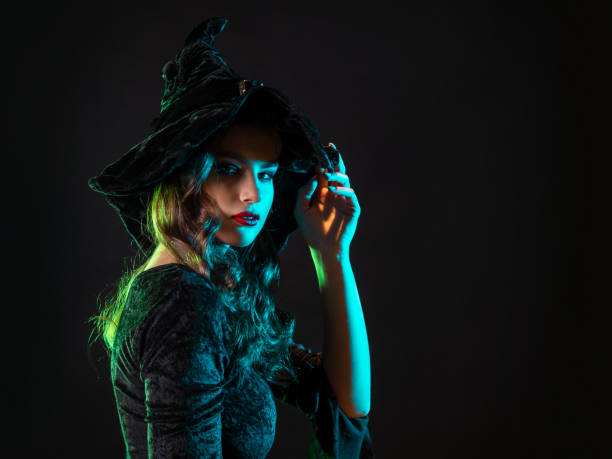 istock A witch creates magic, a young beautiful brunette in a pointed hat 1424003846
