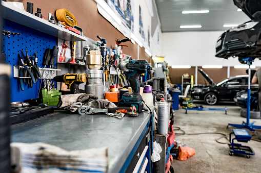 Large workbench with tools at station for vehicle technical servicing close up
