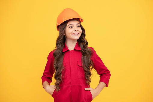 happy teenager girl in safety hard hat, builder.