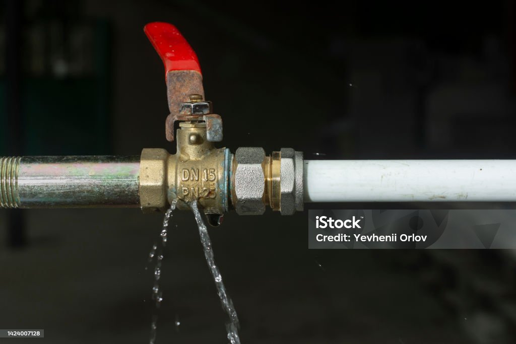Crack on the water tap and a water leak after the spring frost Leaking Stock Photo