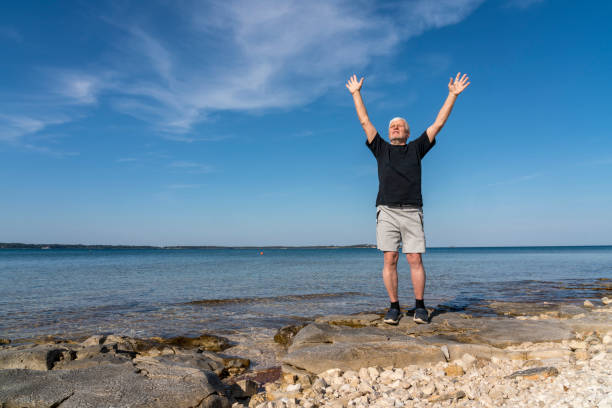istock Men exercising on stony beach early in the morning 1424010232