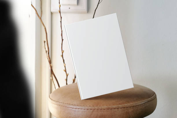 istock Clean minimal book 4x6 mockup floating on leather seat with lamp 1424010880