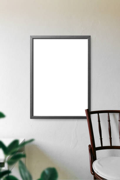 istock Clean minimal frame mockup on white wall with chair and leaves 1424010968