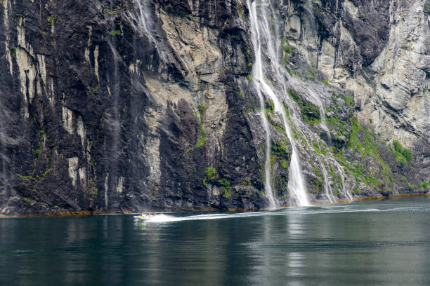Geirangerfjord near Hellesylt in Norway.  There is a Rigid inflatable boat on the Fjord.