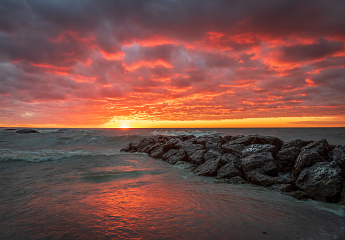 An intense, colorful sunset on the shores of Lake Erie. Captured at Presque Isle State Park in Erie, Pennsylvania.
