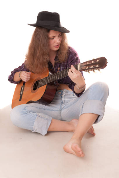 istock girl playing the guitar 1424013245