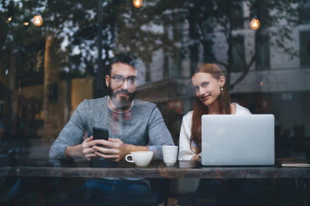 istock Thoughtful couple working together in cafe 1424013267