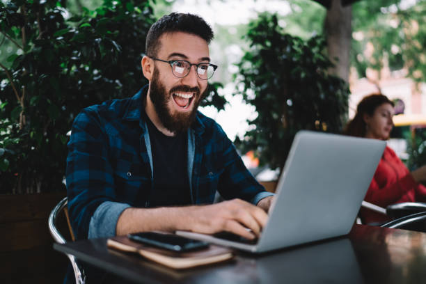istock Man reading exciting news on laptop 1424013389
