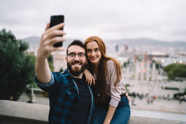istock Cheerful young couple taking selfie on smartphone 1424013993