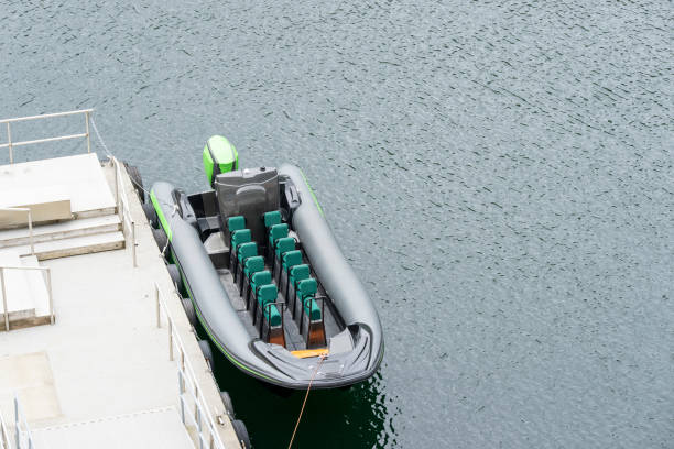 Geirangerfjord near Hellesylt in Norway.  This is Rigid Inflatable Boat moored near to a cruise ship to act as a tender or a tour boat.