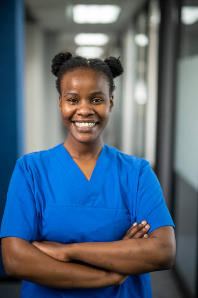istock African nurse with arms crossed smiling to camera 1424022523
