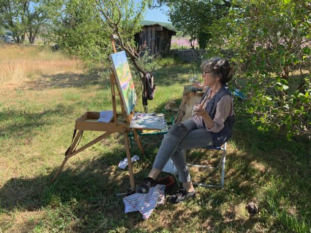 Woman painting en plein air stock photo